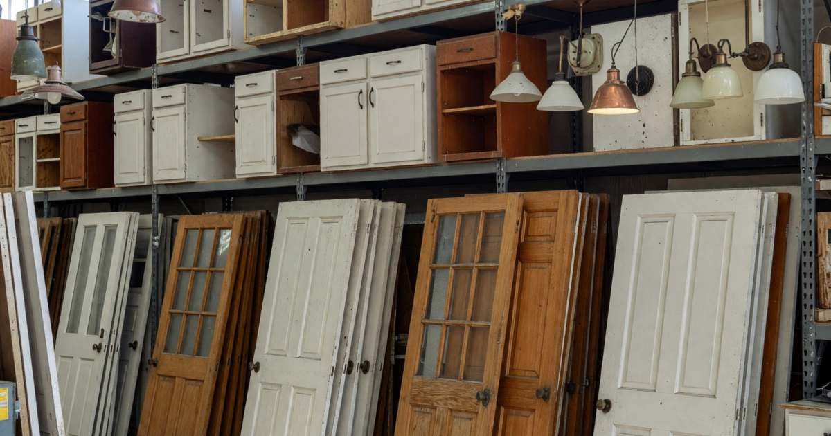 A thrift and reuse store with used doors, cabinets and light fixtures, illustrating ReStore and thrift stores for household items.