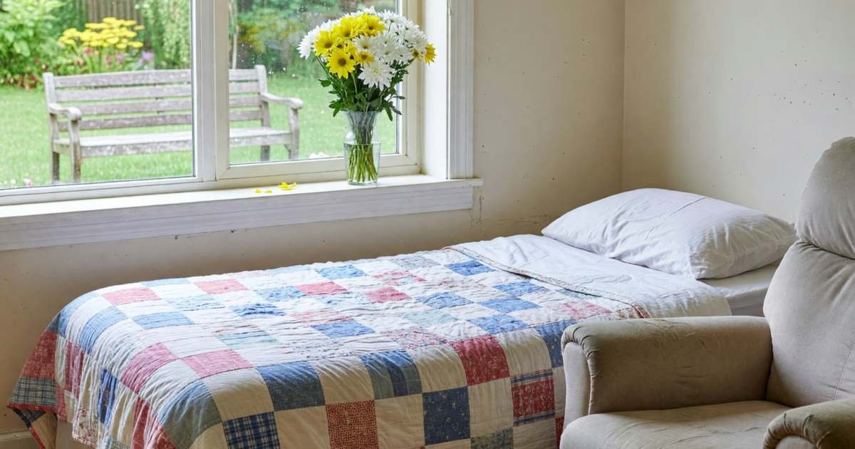 A bright private room in a long-term care home with a bed, a recliner and a window to a garden, illustrating long-term care costs in Ontario in 2026.