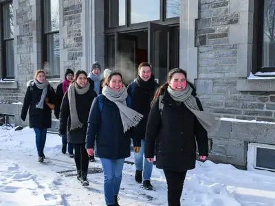 Students walking out of a CÉGEP building in winter.