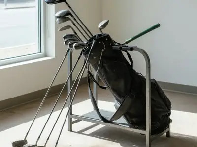 A set of used golf clubs in a bag at a golf shop's trade-in rack.