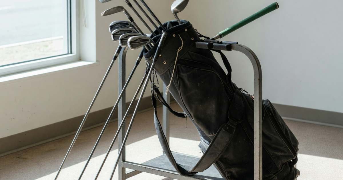 A set of used golf clubs in a bag at a golf shop's trade-in rack, illustrating used golf clubs and club fitting.